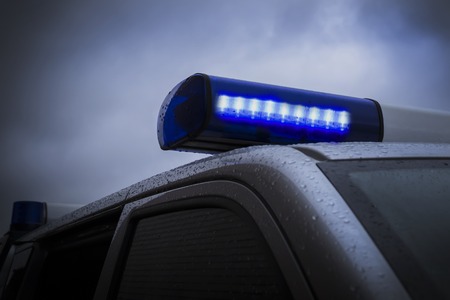 police car on her flashers blue. close-up.の写真素材