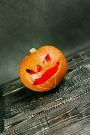Halloween, two pieces or one, in the eye is a lantern camera with burning candles on a black background. Halloween celebration, celebration.の写真素材