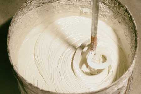 mixing white putty. General repair and renovation. Home improvement. close-up.の写真素材