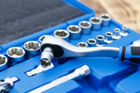 set of heads for car repairs. ratchet on a wooden blue background. ratchet close-up.