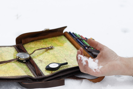 man's hand in it is snow. There are odometer compasses. have toning. concept man failed to get guided in the wild and died.の写真素材