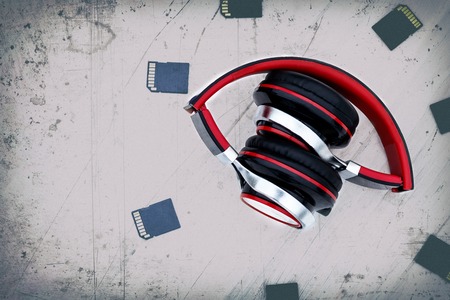 Wooden background in the old style. Musical accessories. headphones are red. memory card. have toning. space for text.の写真素材