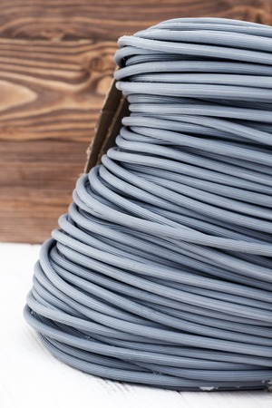 rubber seal. designed for use in windows and mosquito nets and other products. wooden white background. there is toning.の写真素材