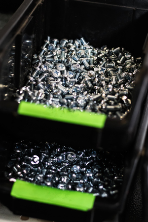 black tray in the store in it are bolts and nuts on the window.の写真素材