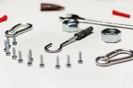 On a white background, there is no insulation, bolts and nuts. they are scattered. shallow depth of cut. there is toning.の写真素材