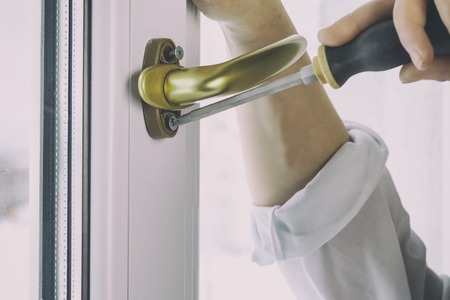 gold pen. Fasten the window handle screw to the PVC windowの写真素材