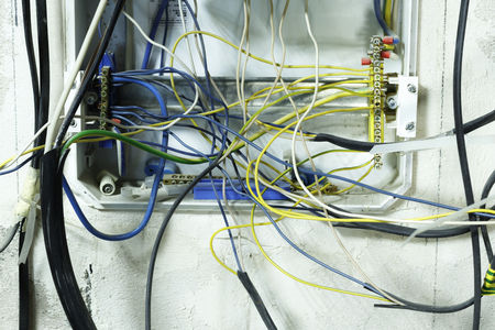 Minsk. Belarus. January 19, 2019. Shield in the wall of the house. wrong connection, automatic distribution, wires are tangled. will lead to short circuit and fire wiringのeditorial素材