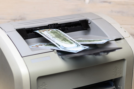 printed dollars. home printer. concept crime fake moneyの写真素材