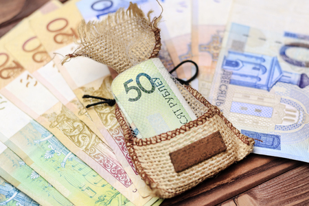 wooden background. on it laid out Belarusian money. In the center in the bag 50 rubles.の写真素材