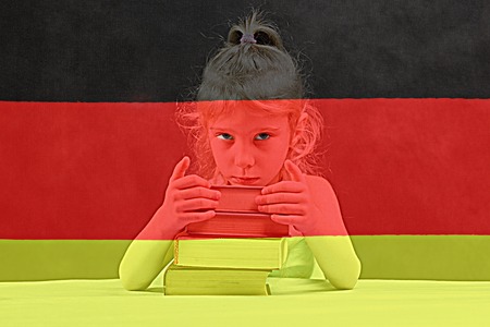 German flag. blonde girl wants to learn German. double exposure.