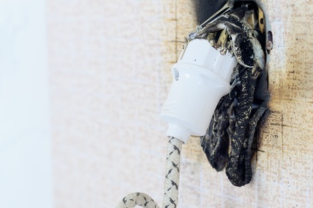 socket on fire. he is real. there is plastic meltingの写真素材