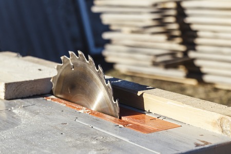 saw blade. machine is ready to work. there is a blackboard in the background.
