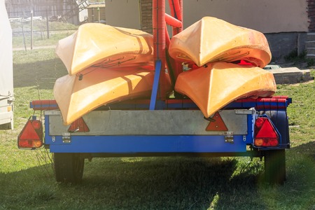 small trailer. blue color on it are small canoe boats. daylightの写真素材