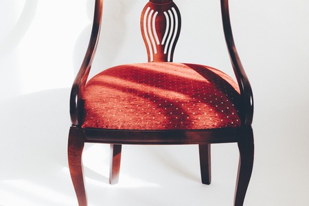 wooden chair with a red seat. on a white background. have toning.の写真素材