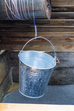 street lighting. well. metal bucket and chain. well have toningの写真素材