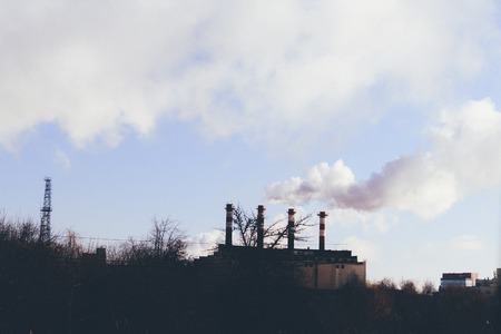 winter cold there is heating in residential buildings. industrial pipe. smoke comes from it.の写真素材
