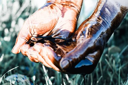 man, hand pour oil into it. have toning. close-upの写真素材