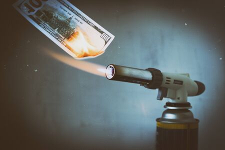 Gas burning, gas burner, burns one hundred dollars. There are artificial scratches. The concept of problems with natural gas, increasing prices and gas losses. there is toningの写真素材