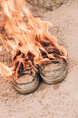 beach sand. Sneakers are very old burn open fire. have toning.の写真素材