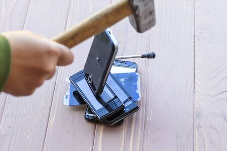daylight. hammer hit on the phones. in one of them there is a metal nail.