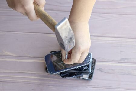 daylight. hammer hit on the phones. in one of them there is a metal nail.