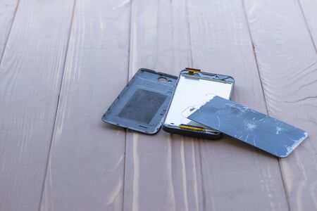daylight. broken mobile phone. wooden background have toningの写真素材