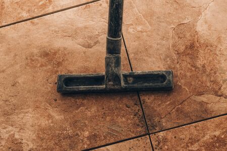 close-up. vacuum cleaner brush to vacuum tile. the next stage is the fugue.の写真素材