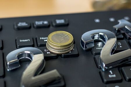 black keyboard. close-up. on it are laid out numbers of metal 2021 in the center of the coin 1 euro