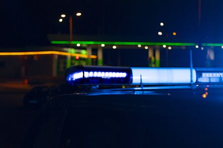 night time. blue police car with selective focus and blur bokeh