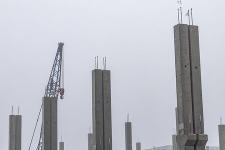 very heavy fog. concrete supports. frame of the future home. monolith.