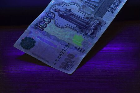 fake. 100 rubles in the ultraviolet. close-up businessの写真素材