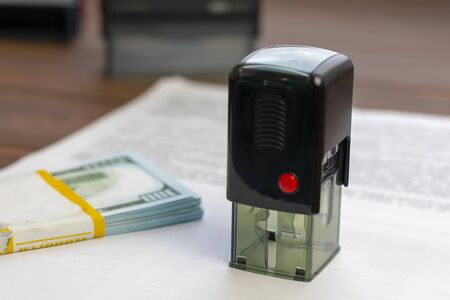 Dark color print. Near banknotes dollars. The concept is a favorable solution to the issue through bribes.の写真素材