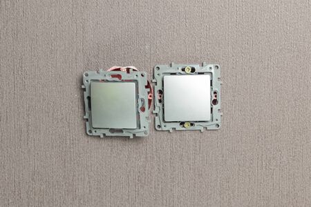 the master electrician sets the switch. Close-up. The room is colored. The switch is brown. The keys...