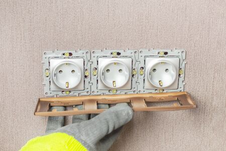 The wizard completes the installation of outlets. Sets the decorative brown frame. And puts the...