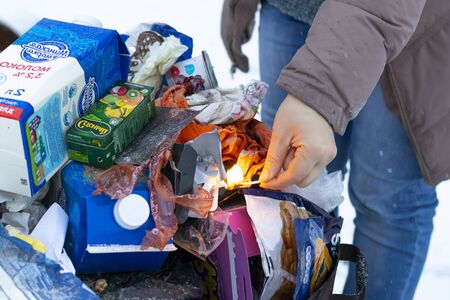Minsk. Belarus, January 29, 2020. Burning garbage in a metal barrel. The concept of the destruction...