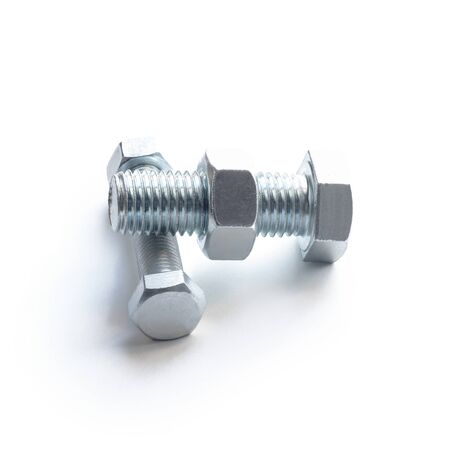 A bolt and nut made of metal. Lie on a white background. Isolated on a white background. Close-up.