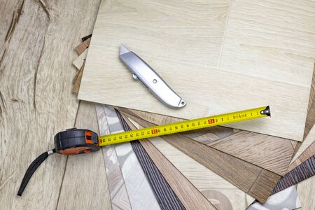 linoleum close-up. Samples and tape measure and cutting knife. There is a tint.
