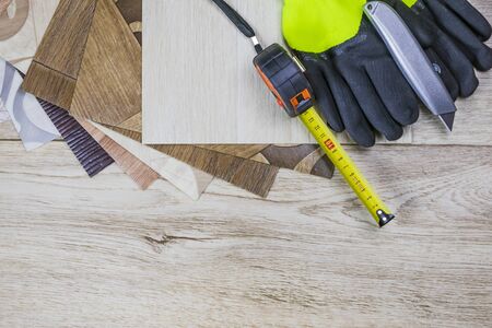 linoleum close-up. Samples and tape measure and cutting knife. There is a tint.