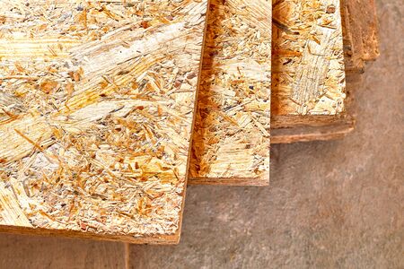OSB slab building material made from reborn sawdust. They are stacked. Close-up.の写真素材