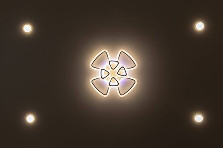 stretch ceiling in white. A decorative chandelier hangs in the center.