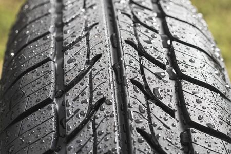 New tire. There are raindrops on it. The tread pattern is looking at us. Close-upの写真素材