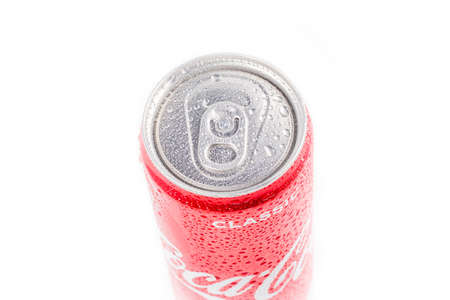 Minsk. Belarus. October 23, 2020. Studio lighting. A red metal can of Coca-Cola is covered with...