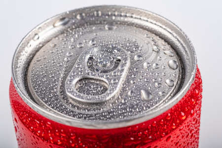 Studio lighting. aluminum red can with small drops of water on it. Chilled. The cover is open. On white backgroundの写真素材