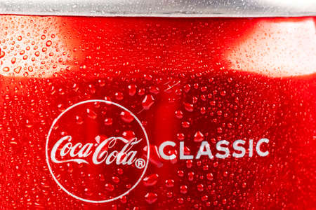 Minsk. Belarus. October 23, 2020. Studio lighting. A red metal can of Coca-Cola is covered with...