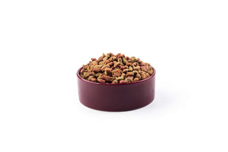 studio lighting. the animal feed is poured into a bowl. On a white background. Close-up