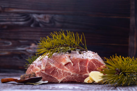 dark wooden background in retro, grunge style. Pork neck tenderloin. Also near spices and seasonings for its preparation.の写真素材