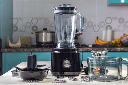 Natural light. black food processor. Near the nozzle for use. In the background is a kitchen for cookingの写真素材