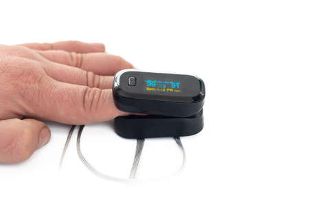 Portable black pulse oximeter on a white background. Monitoring the oxygen level at home.