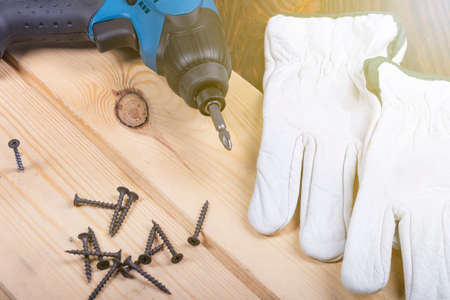studio lighting. electric impact screwdriver. Wooden background in retro style. Soft focus. Close-upの写真素材