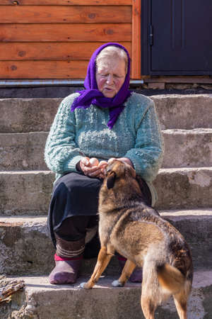 close-up. An elderly woman with dirty nails holds three chicken eggs in her hands,の写真素材